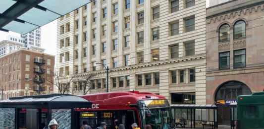 Riders board the RapidRide E, which gets a big boost from the STBD, on Third Avenue in Downtown Seattle. (Photo by Doug Trumm)