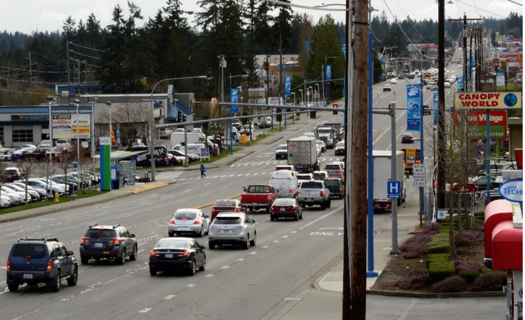 A busy state highway with narrow sidewalks