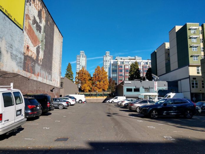 A parking lot in Belltown with towers behind