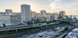 An aerial photo shows Tacoma's waterfront separated from its downtown towers by its elevated I-705 freeway.