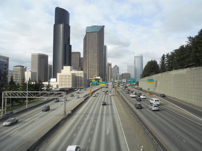 The Seattle skyline rises above the I-5 freeway trench in South Downtown.