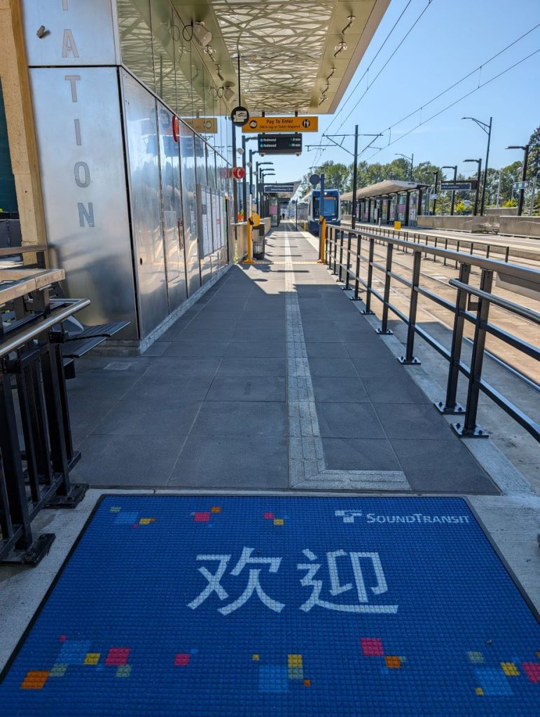 The northbound platform at Overlake station with a light rail vehicle boarding