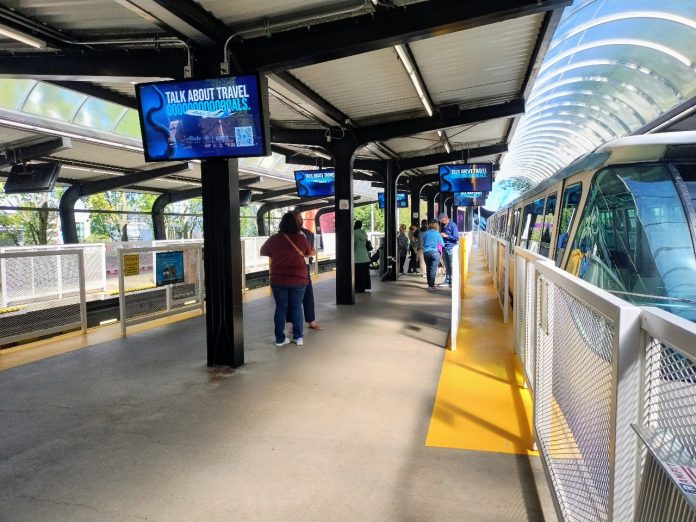 A small crowd waits for the doors to open on a monorail train at Seattle Center