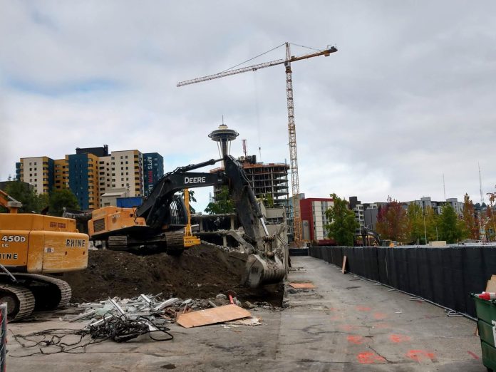 Construction cranes build more housing near Seattle's Space Needle.