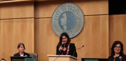 Rinck is flanked by Seattle City President Sara Nelson and Tammy Morales.