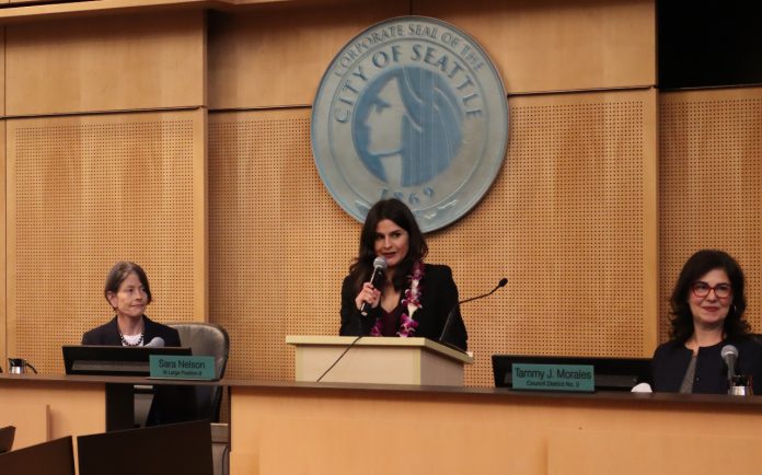 Rinck is flanked by Seattle City President Sara Nelson and Tammy Morales.