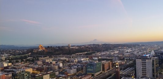 A view from the Smith Tower at dusk looking toward Beacon Hill with Mount Rainier in the distance