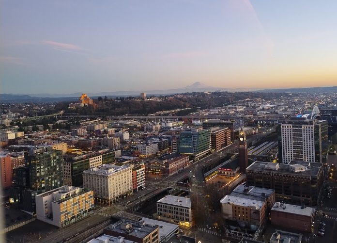 A view from the Smith Tower at dusk looking toward Beacon Hill with Mount Rainier in the distance