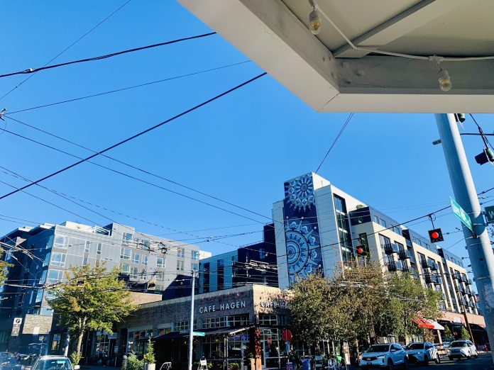 Cafe Hagen is on the corner with a seven-story building in the background.