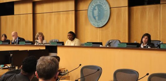 In the foreground are OPCD planners and in the background are city councilmembers at the dais.