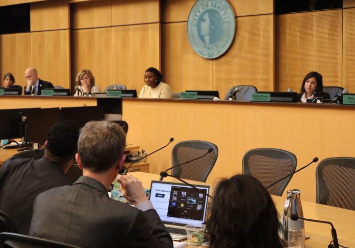 In the foreground are OPCD planners and in the background are city councilmembers at the dais.