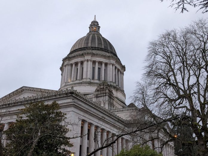 The Olympia capital building with some trees in the foreground.