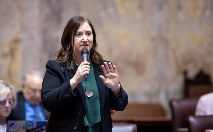 Frame holds a microphone on the floor of senate chambers.