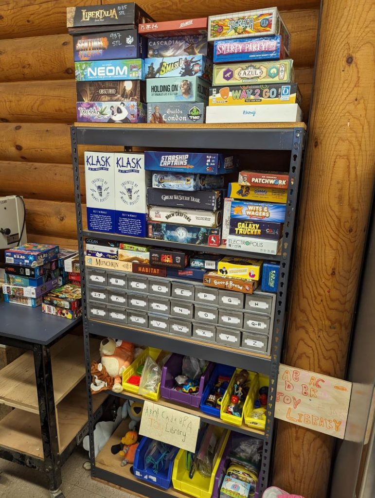 A shelving unit is filled with board games.